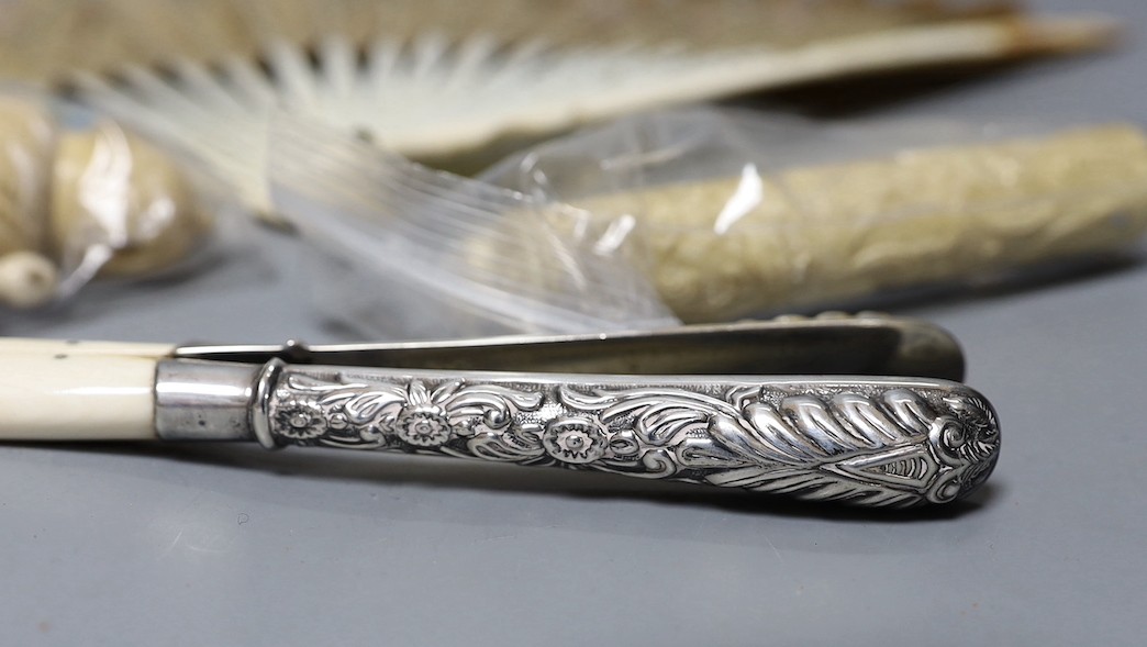 A mix collection of antique ivory to include needle cases, silver mounted gloves stretcher, etc and nut sewing accessories